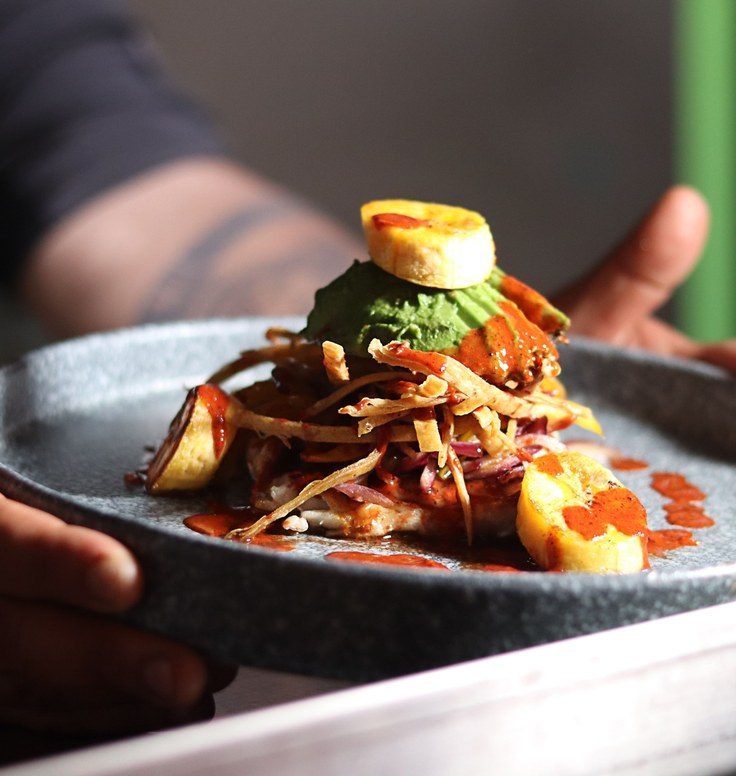 A chef presenting a plated dish at Textures