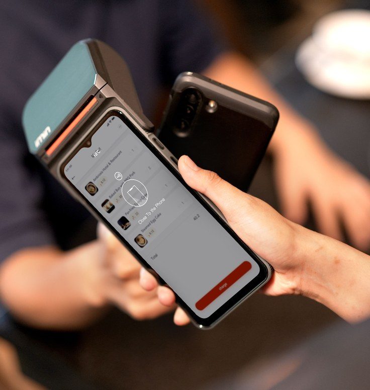A guest paying by card on a mobile payment terminal